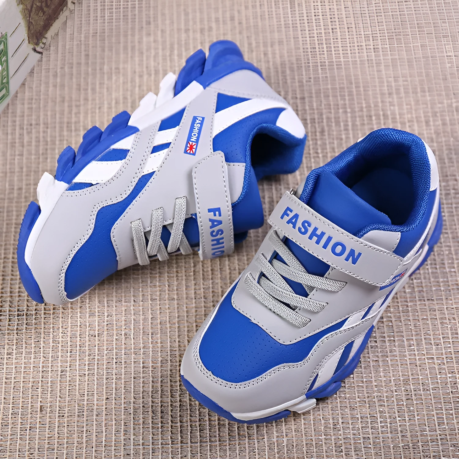 Children's grey Velcro running shoes with synthetic leather upper and rubber sole.
