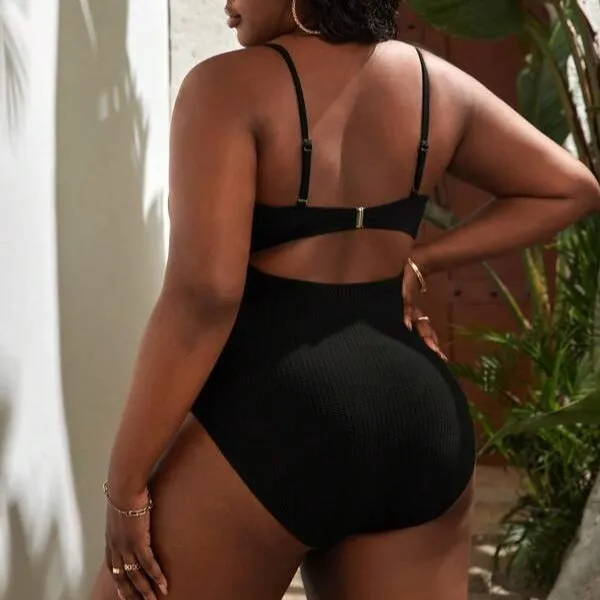 Plus size women's black slimming one-piece swimsuit with triangle sling design