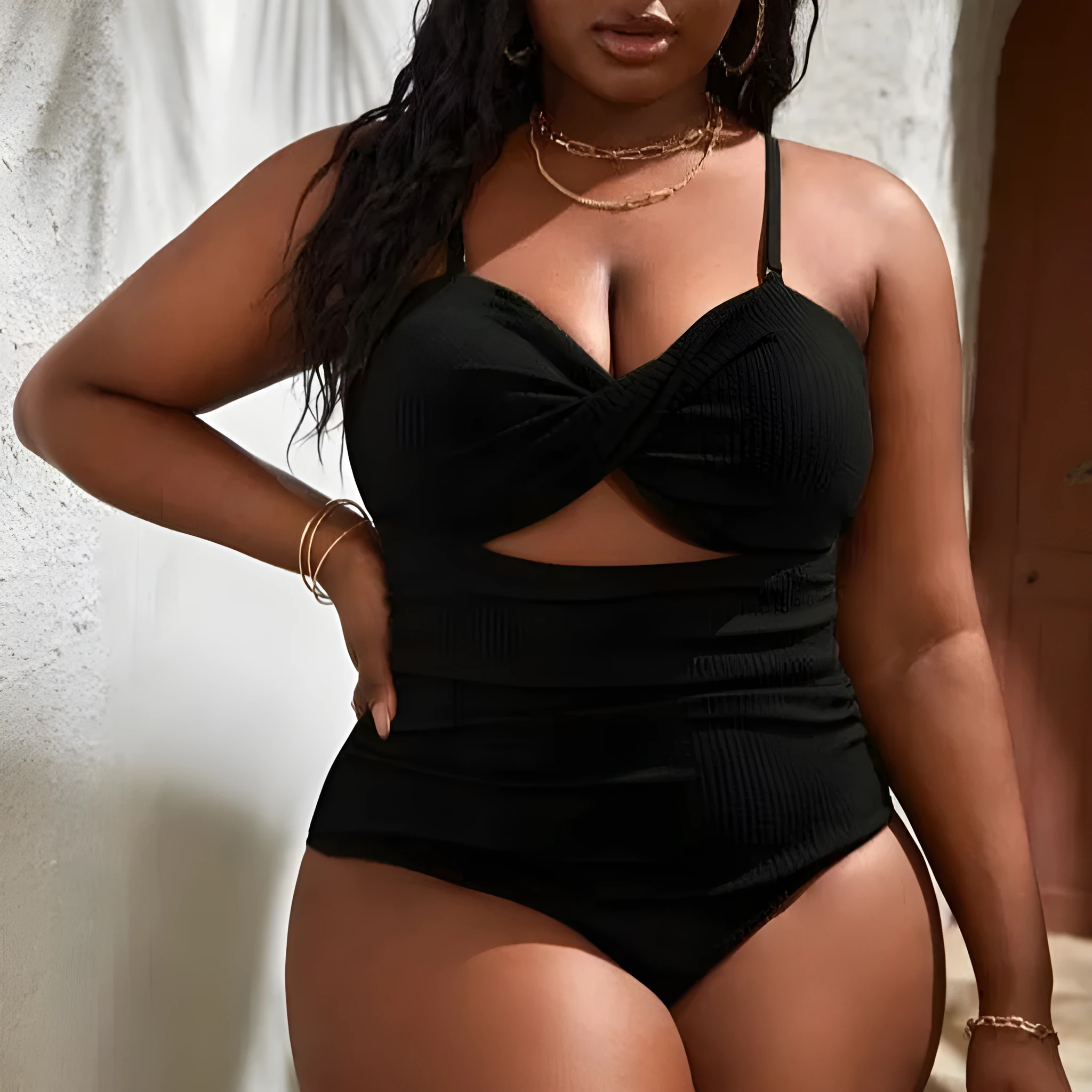 Plus size women's black slimming one-piece swimsuit with triangle sling design