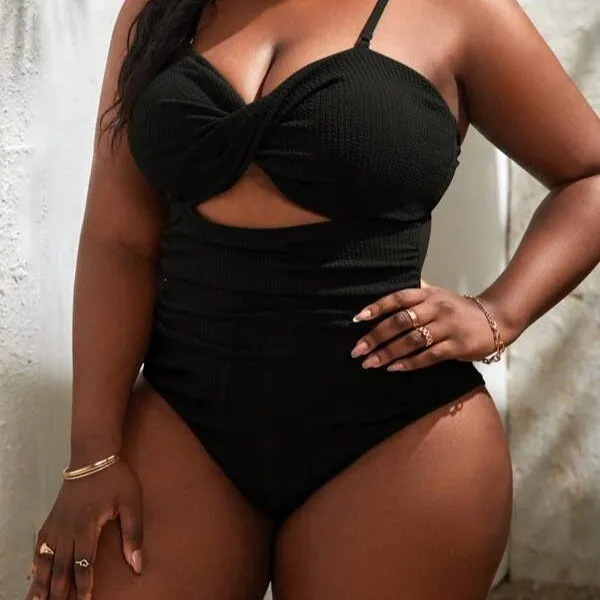 Plus size women's black slimming one-piece swimsuit with triangle sling design