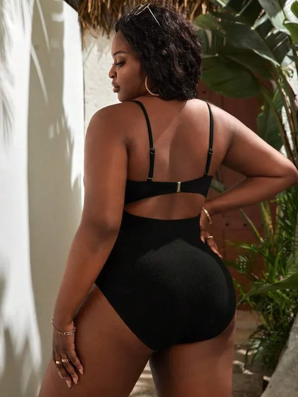 Plus size women's black slimming one-piece swimsuit with triangle sling design