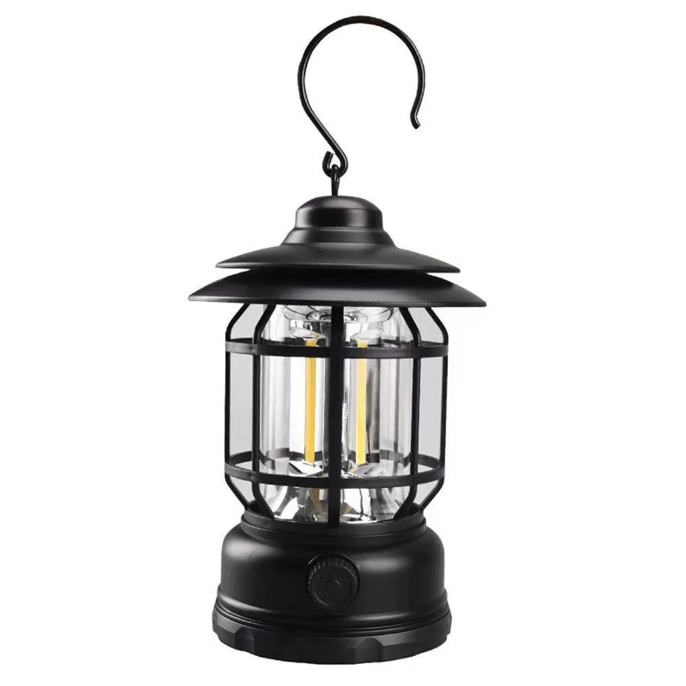 Portable head lamp camping lantern in dark green, showing compact size for hands-free use.
