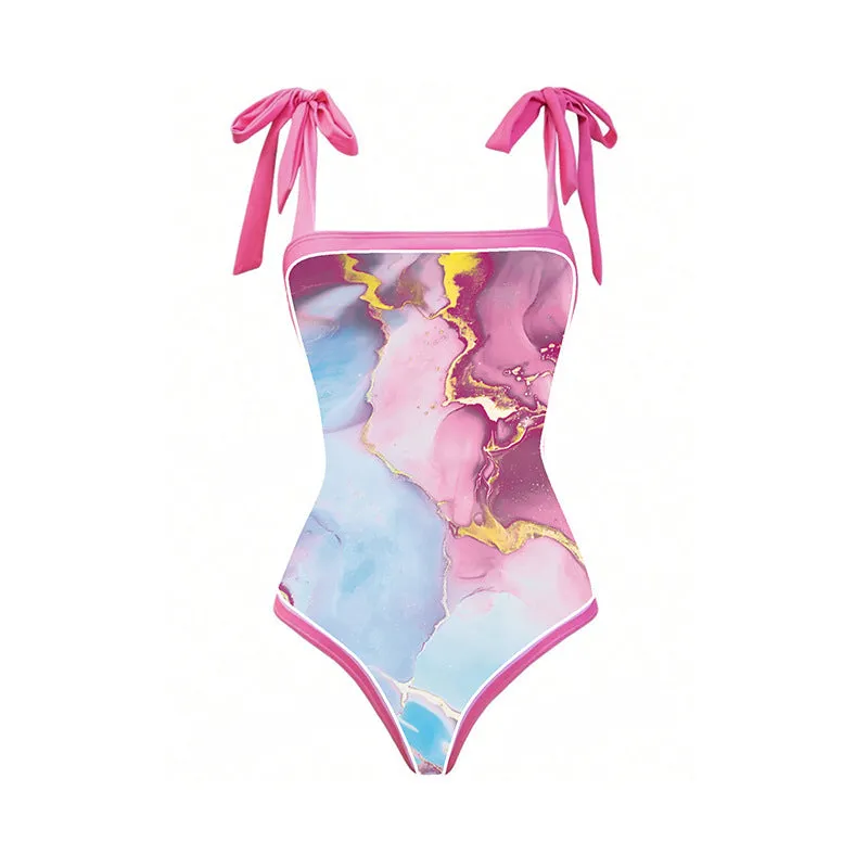 Pink printed women's one-piece swimsuit with a sheath silhouette and attached skirt.