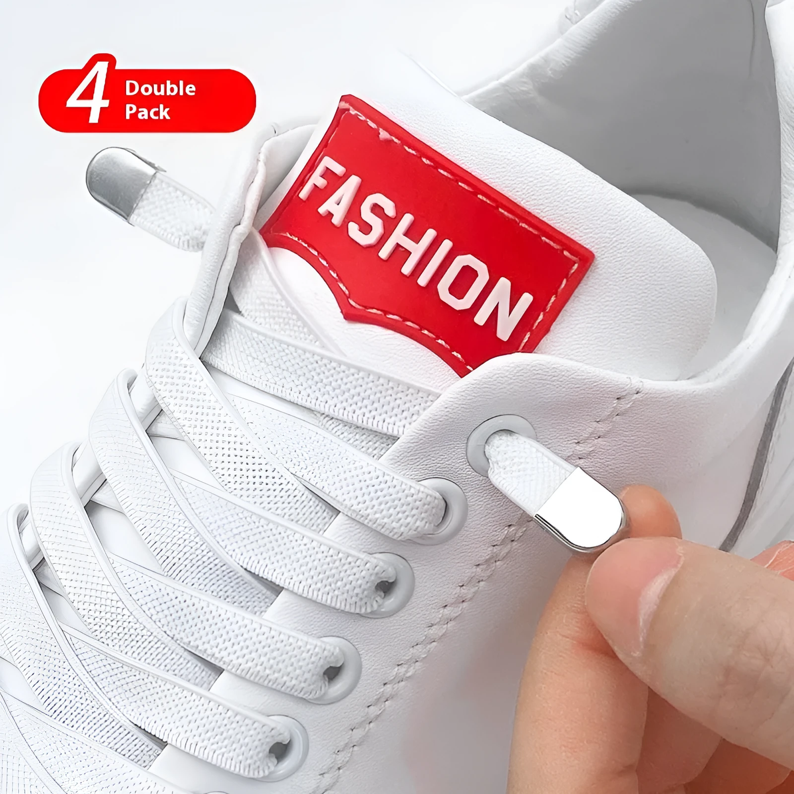 Elastic lace-free white shoelaces with flat buckle on a trainer, showing easy tie-free fastening