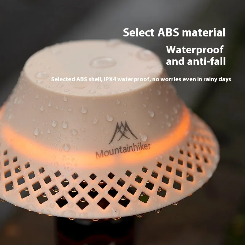 Beige and grey wine bottle-shaped camping lantern showing its compact size and light gear switch.