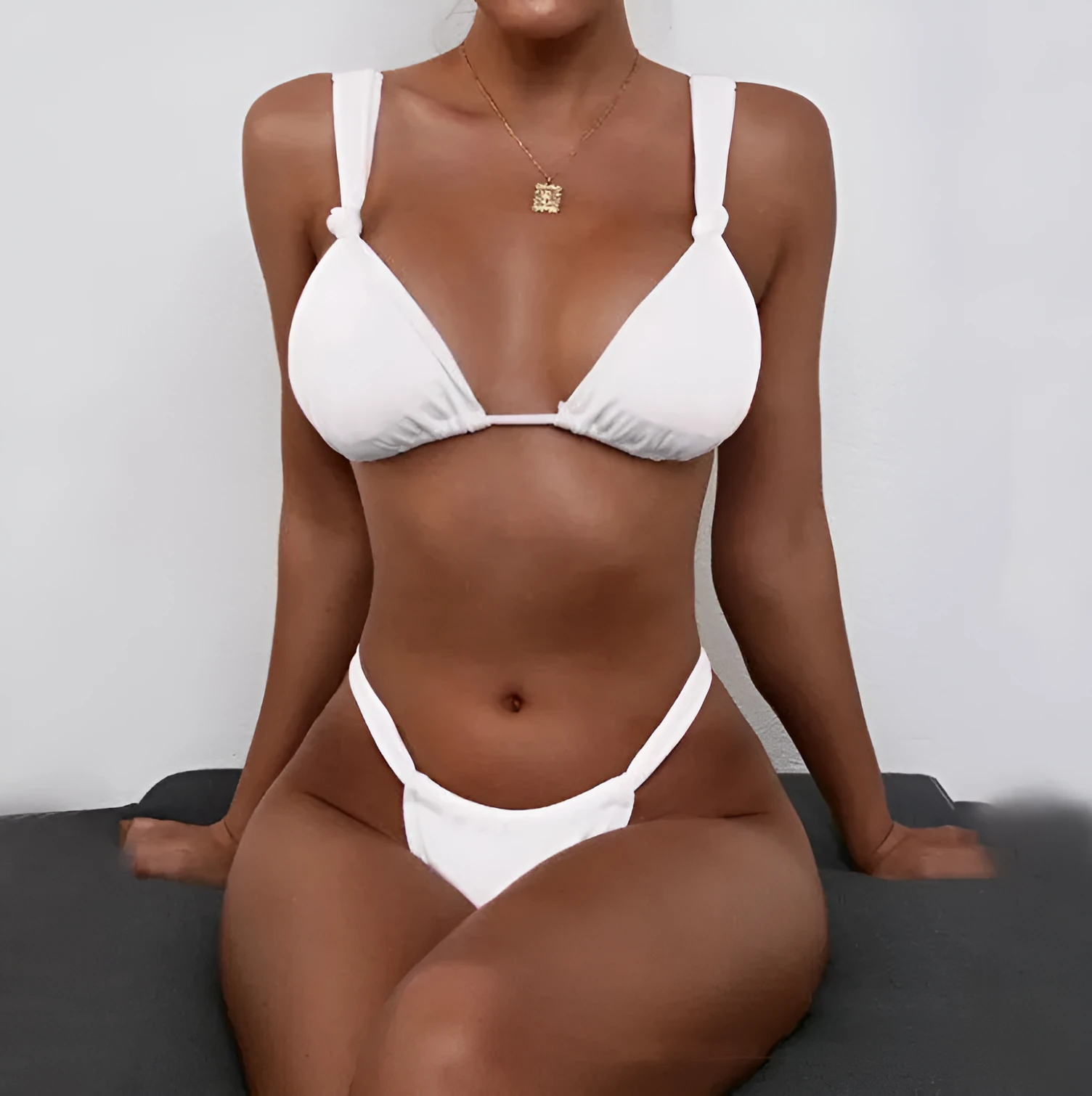 Women's pink bikini with a knotted front and pleated split strap design.