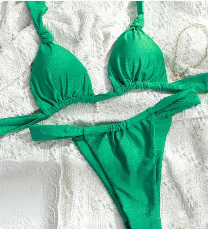Women's pink bikini with a knotted front and pleated split strap design.