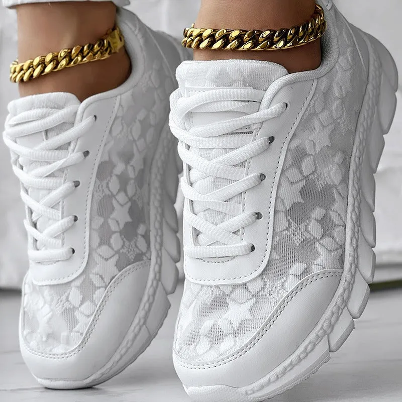 Women's white canvas running shoe with flat heel and round toe on a plain background