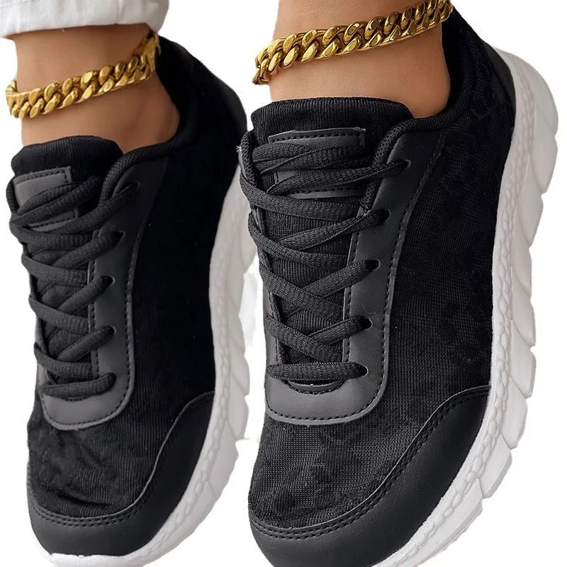 Women's white canvas running shoe with flat heel and round toe on a plain background