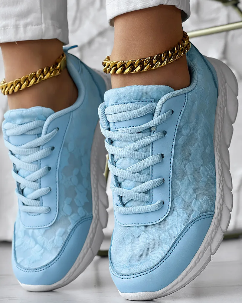 Women's white canvas running shoe with flat heel and round toe on a plain background