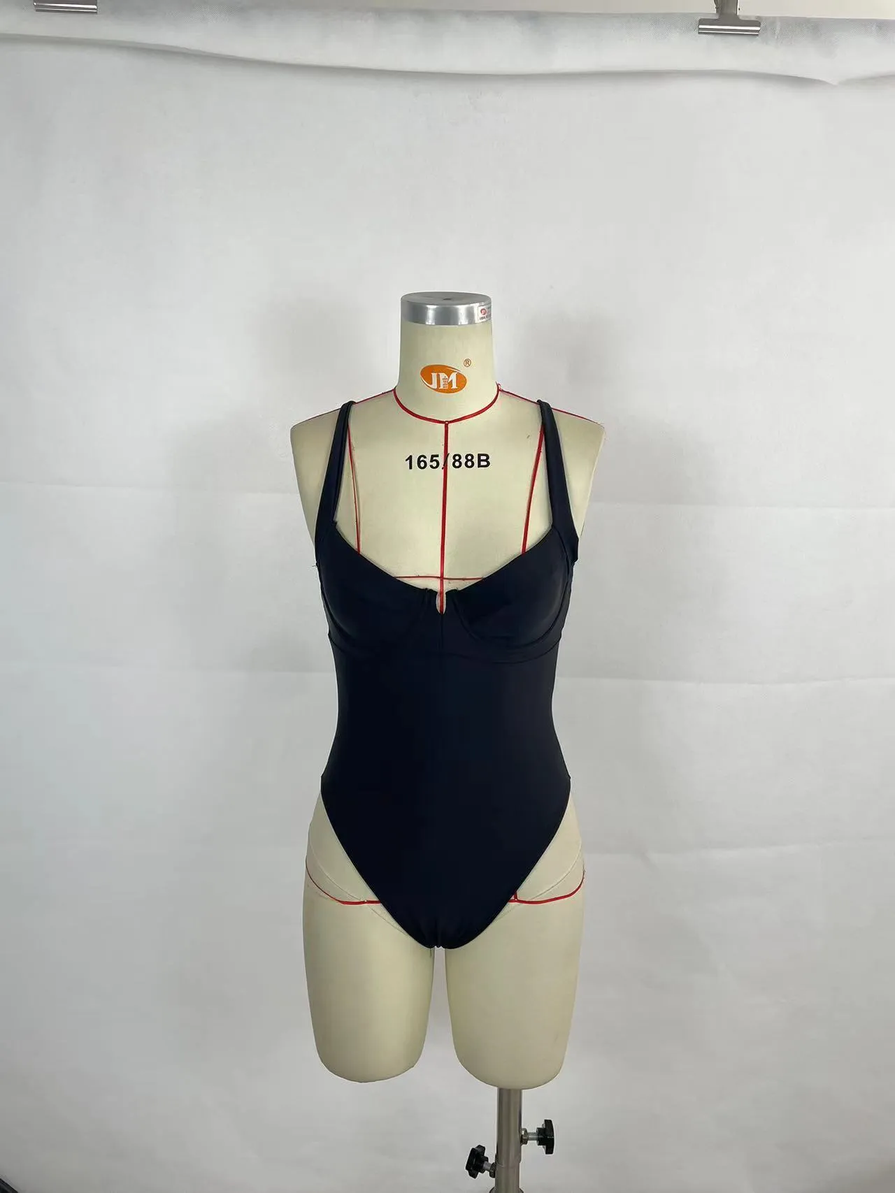 Women's contrast colour one-piece swimsuit in black and red, polyester outer with nylon lining, briefs-style cut for swimming and wading.