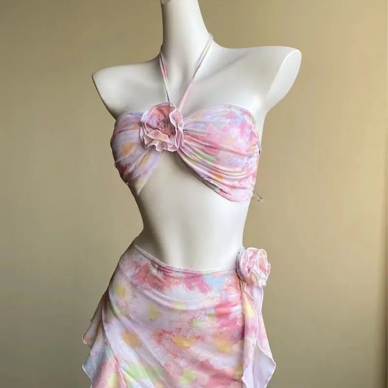 Women's floral split skirt-style swimsuit bikini three-piece set in pink with top, skirt, and panties