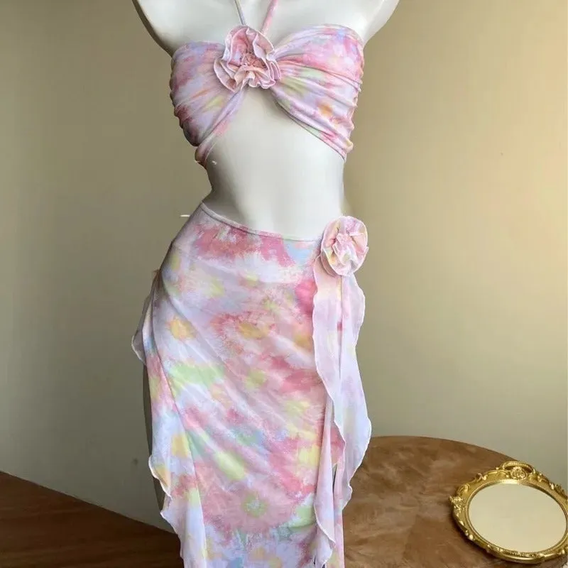 Women's floral split skirt-style swimsuit bikini three-piece set in pink with top, skirt, and panties
