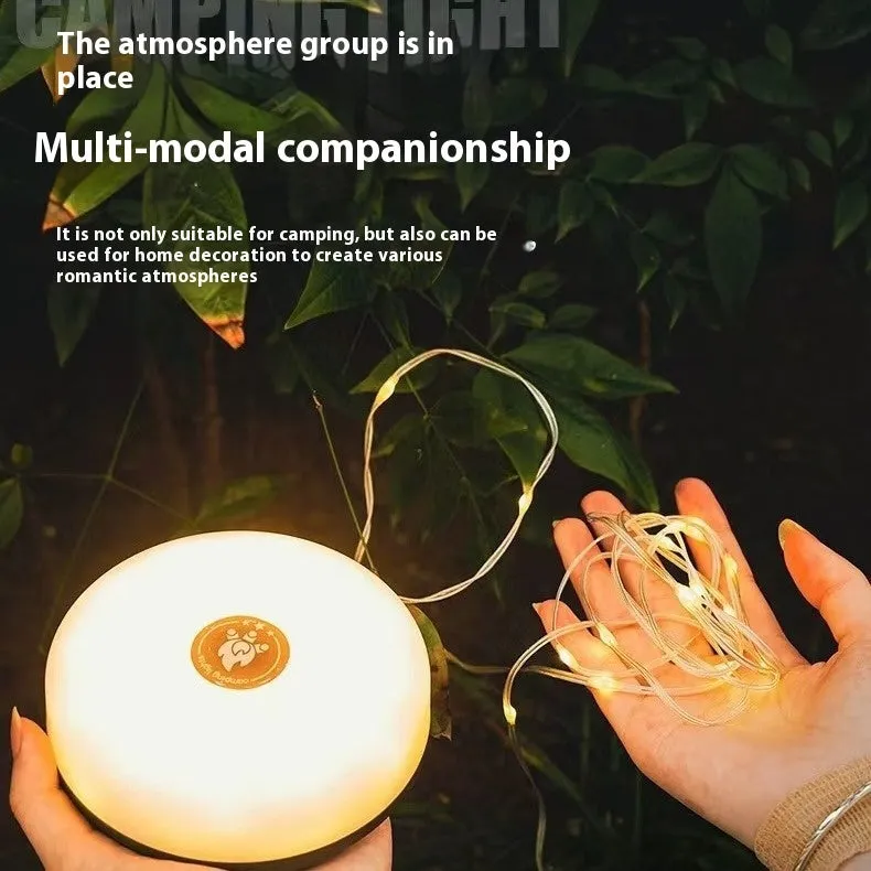 Charging multifunctional camping lantern with warm and colourful light modes on a campsite table