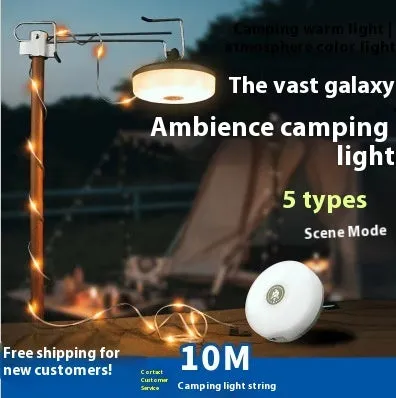 Charging multifunctional camping lantern with warm and colourful light modes on a campsite table