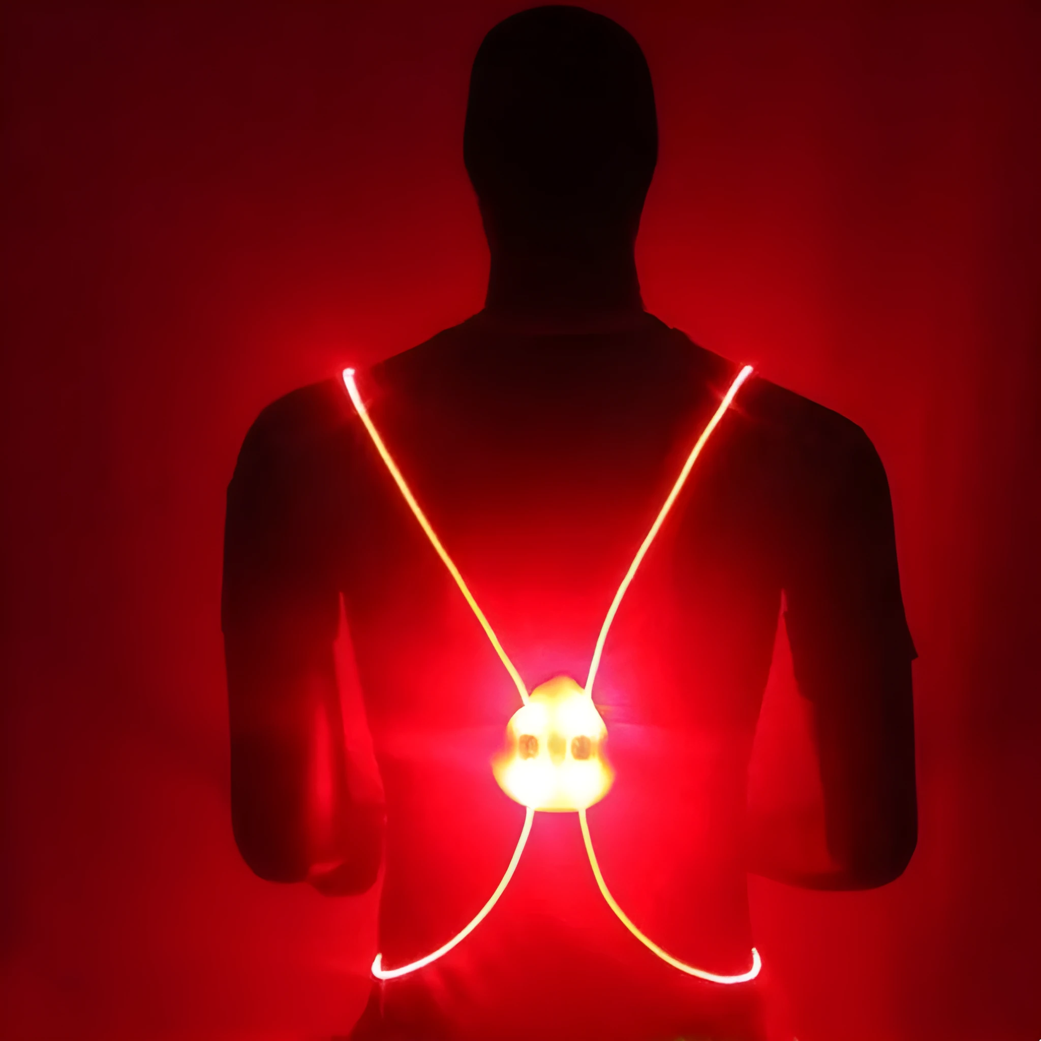 Red reflective vest with LED fibre optic lights visible on a person cycling at night