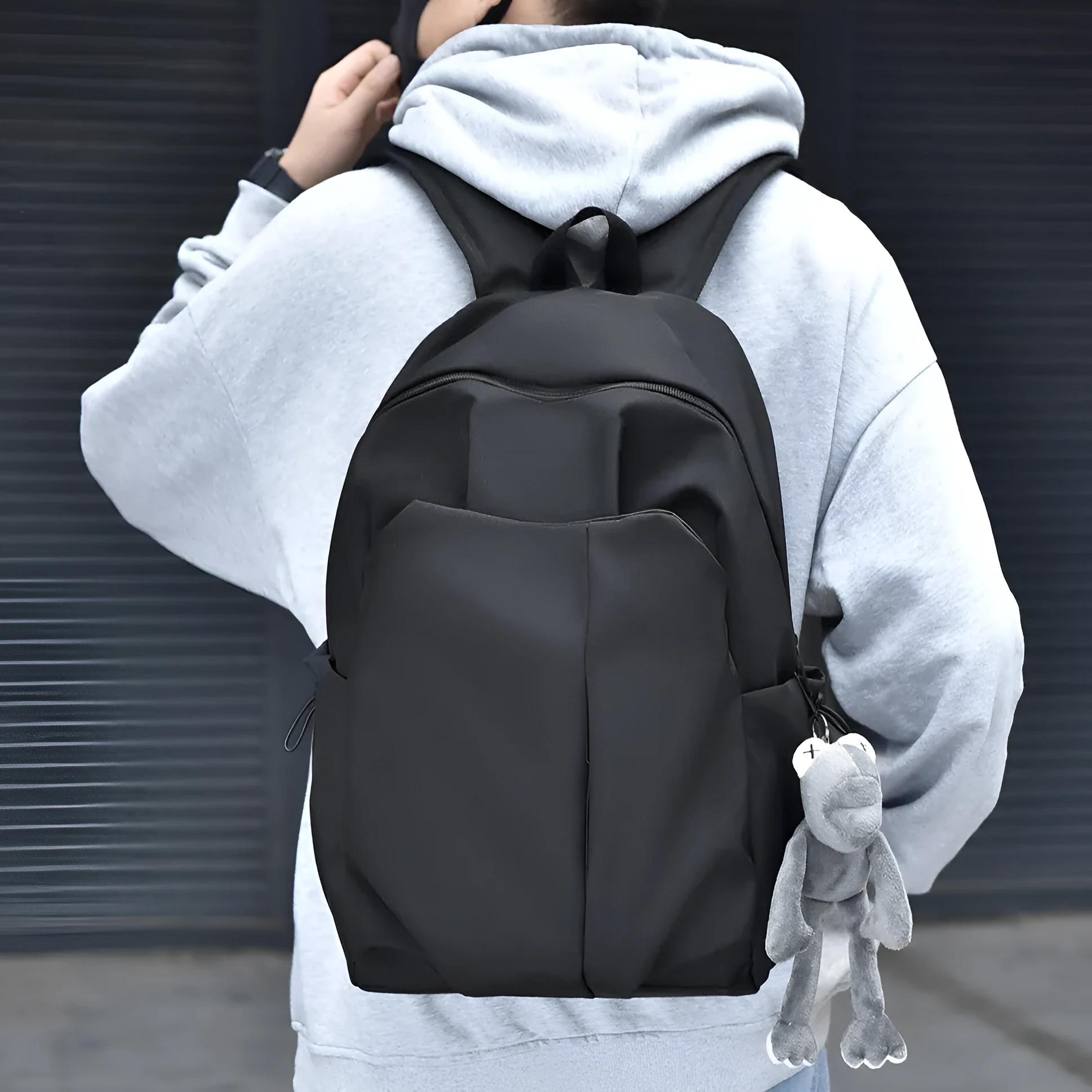 Casual large capacity Oxford cloth backpack in black with curved shoulder straps and sewing line detail