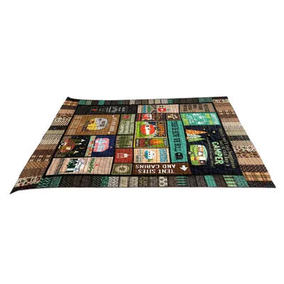 Outdoor camping blanket made from soft 100% polyester in a picnic setting with green grass background