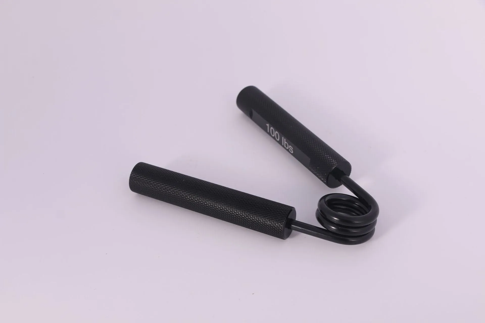 Aluminium alloy hand gripper with spring steel resistance on a neutral background