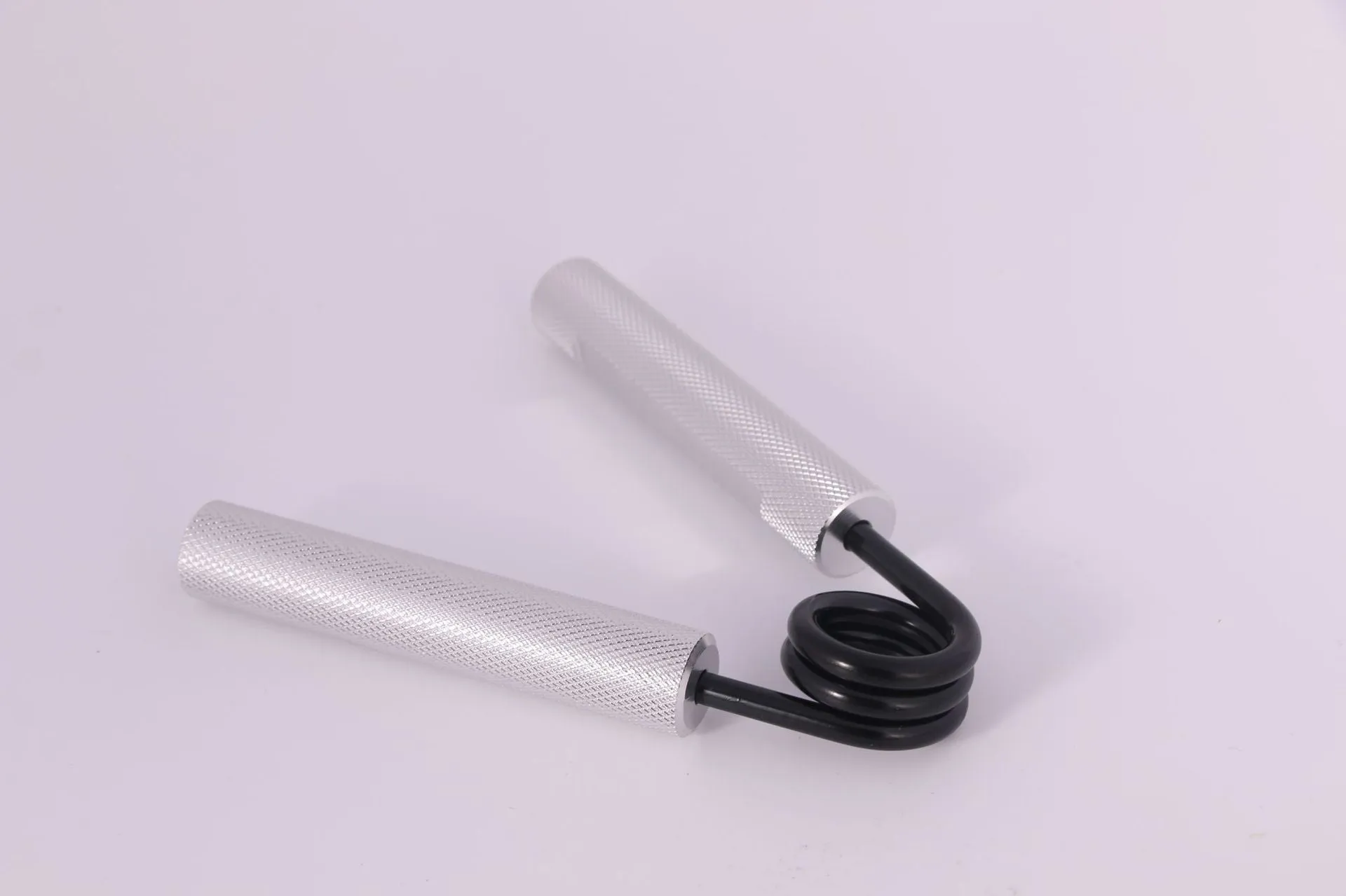 Aluminium alloy hand gripper with spring steel resistance on a neutral background