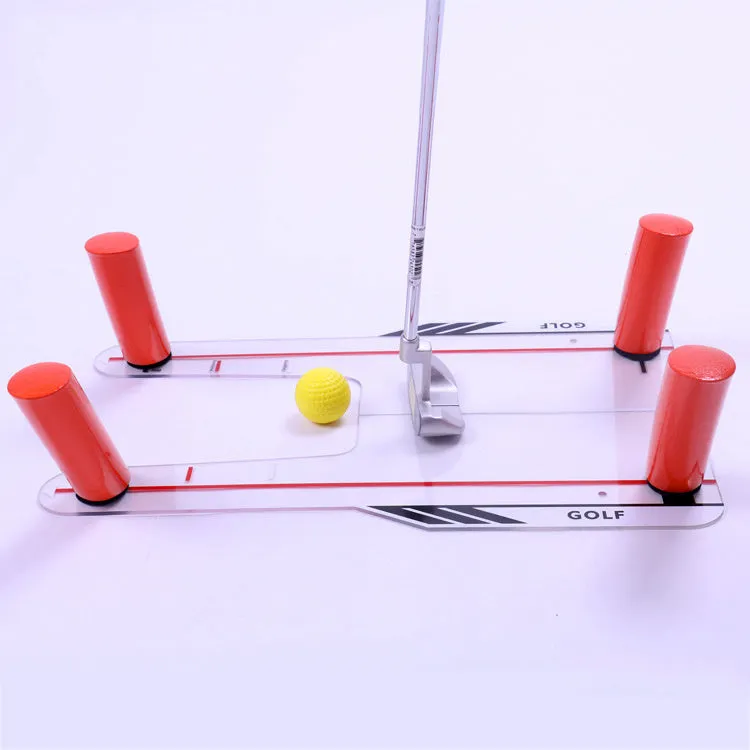 Red plastic putting practice mirror for golf training aid on green surface