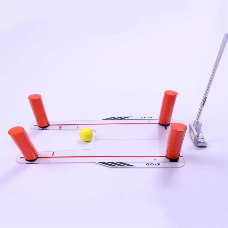 Red plastic putting practice mirror for golf training aid on green surface