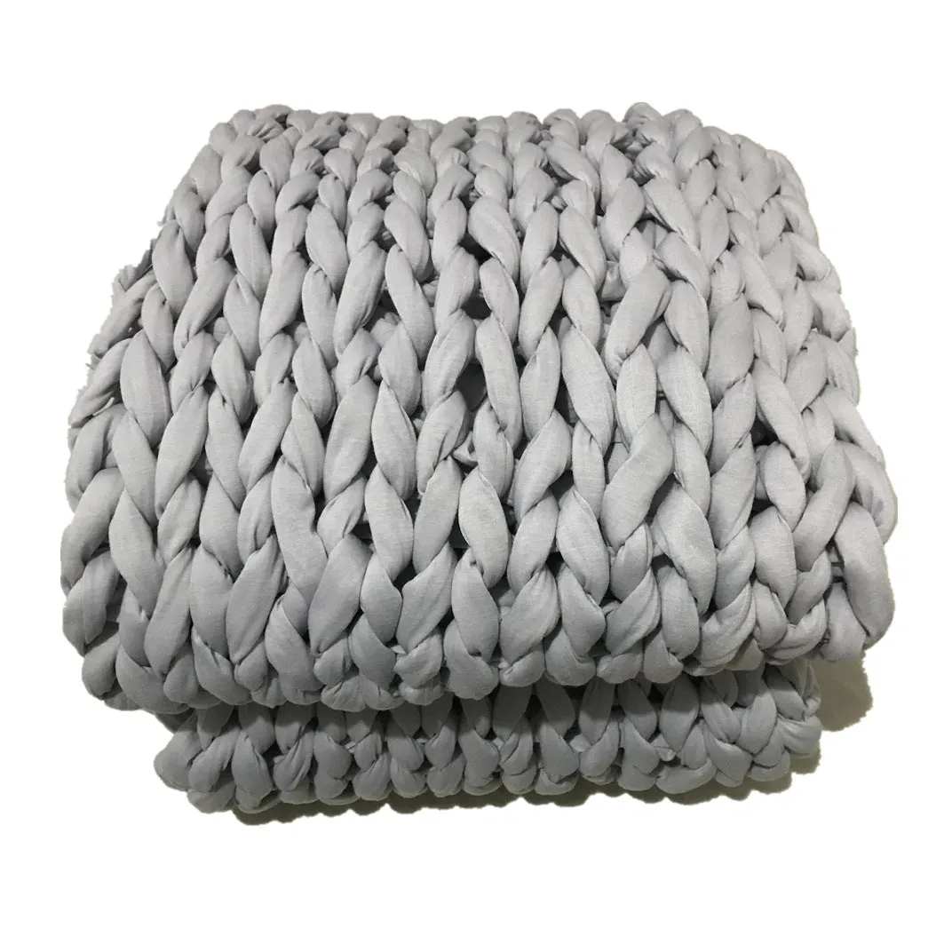 Hand-woven chenille polyester weighted blanket in beige solid colour, 200x200cm size on a bed.