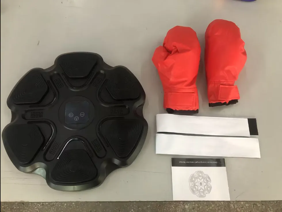 Smart music boxing machine wall target with LED lights and focus gloves on white wall.