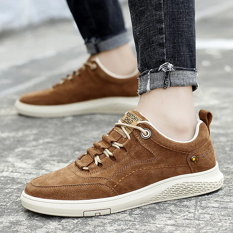 Men's brown leather sports shoes with suede finish and anti-skid plastic sole on concrete background
