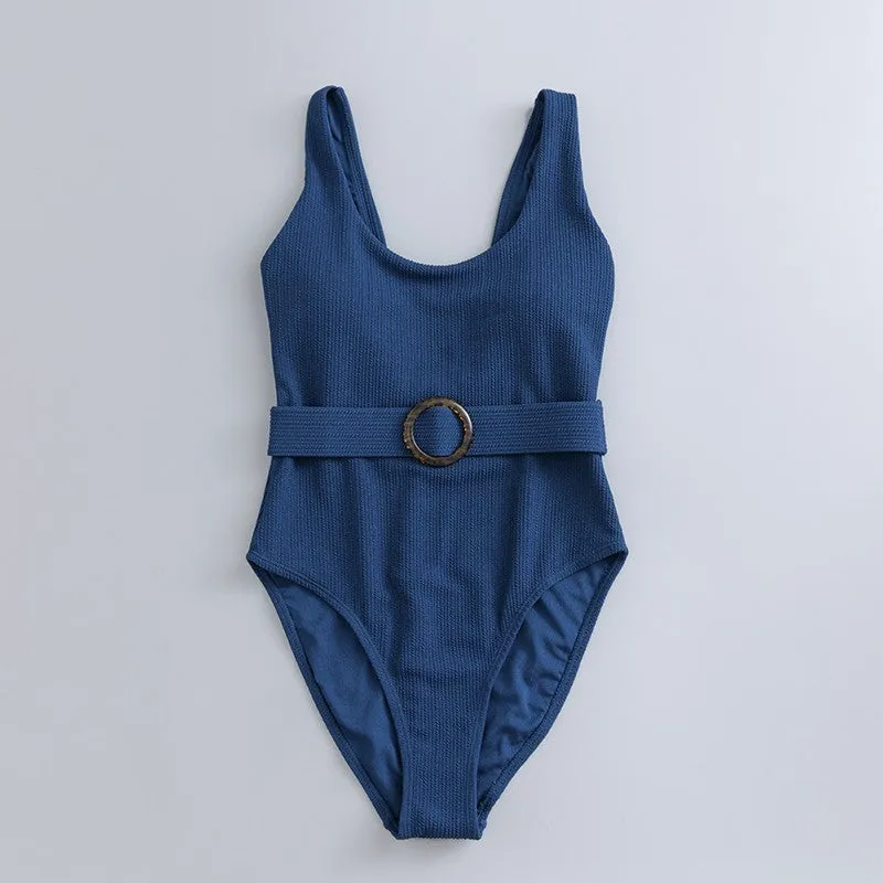 Navy blue one-piece women's swimsuit with a triangle neckline and slimming fit on a mannequin.