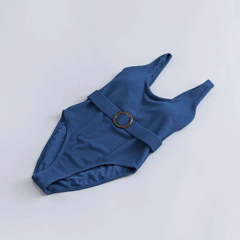 Navy blue one-piece women's swimsuit with a triangle neckline and slimming fit on a mannequin.