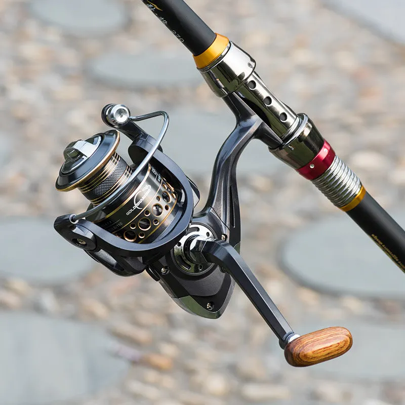 Telescopic fishing rod combo with carbon fibre rod and spinning reel with solid wood handle on a beach