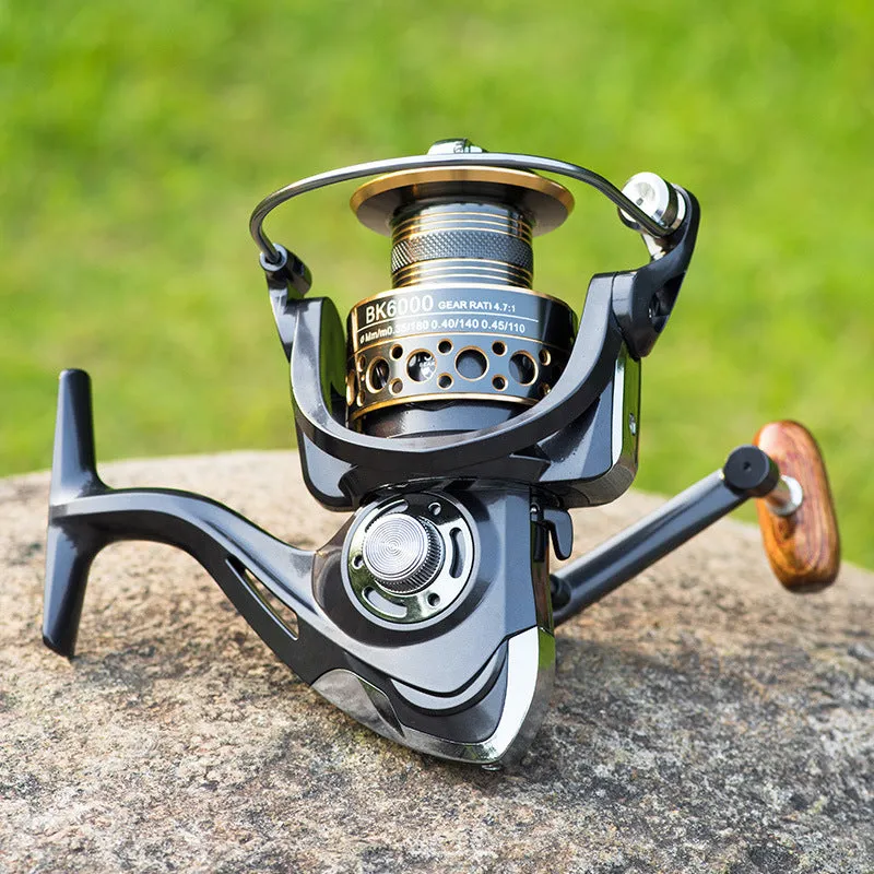 Telescopic fishing rod combo with carbon fibre rod and spinning reel with solid wood handle on a beach