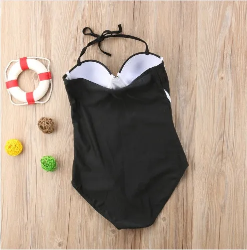 Black one-piece women's swimsuit on display, available in sizes S to XL