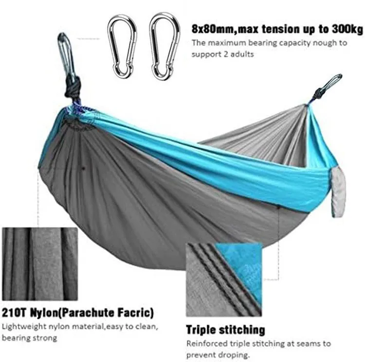 Blue nylon parachute cloth camping hammock hanging between two trees
