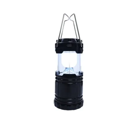COB LED camping lamp in black with telescopic body and hook, standing on a wooden surface