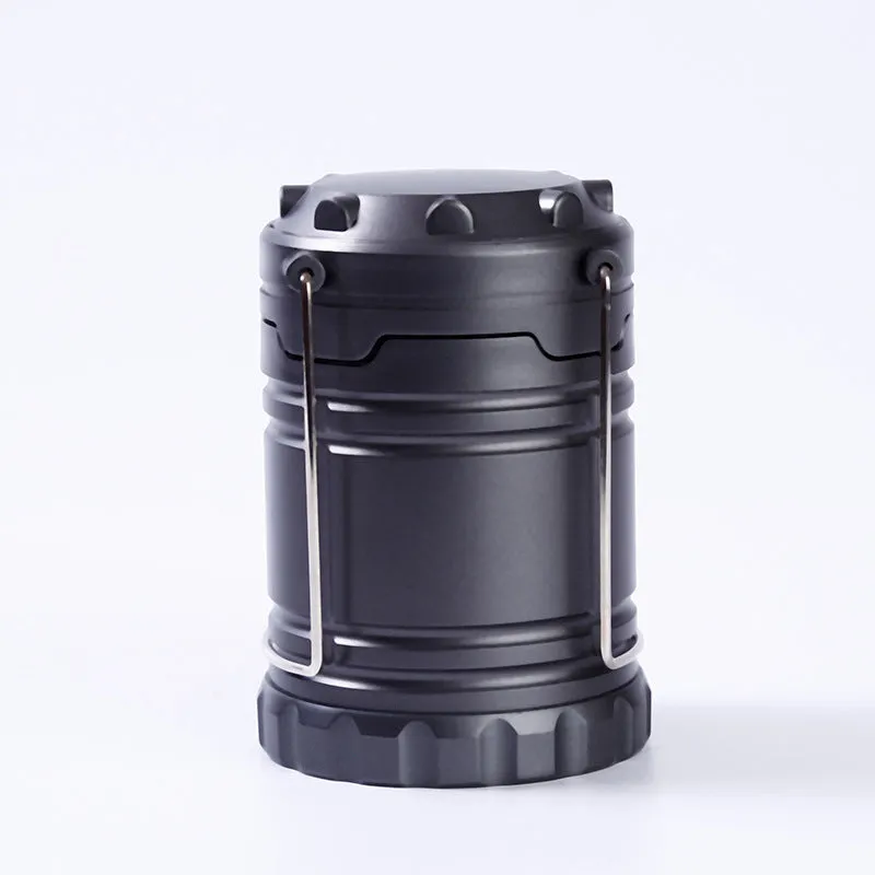 COB LED camping lamp in black with telescopic body and hook, standing on a wooden surface
