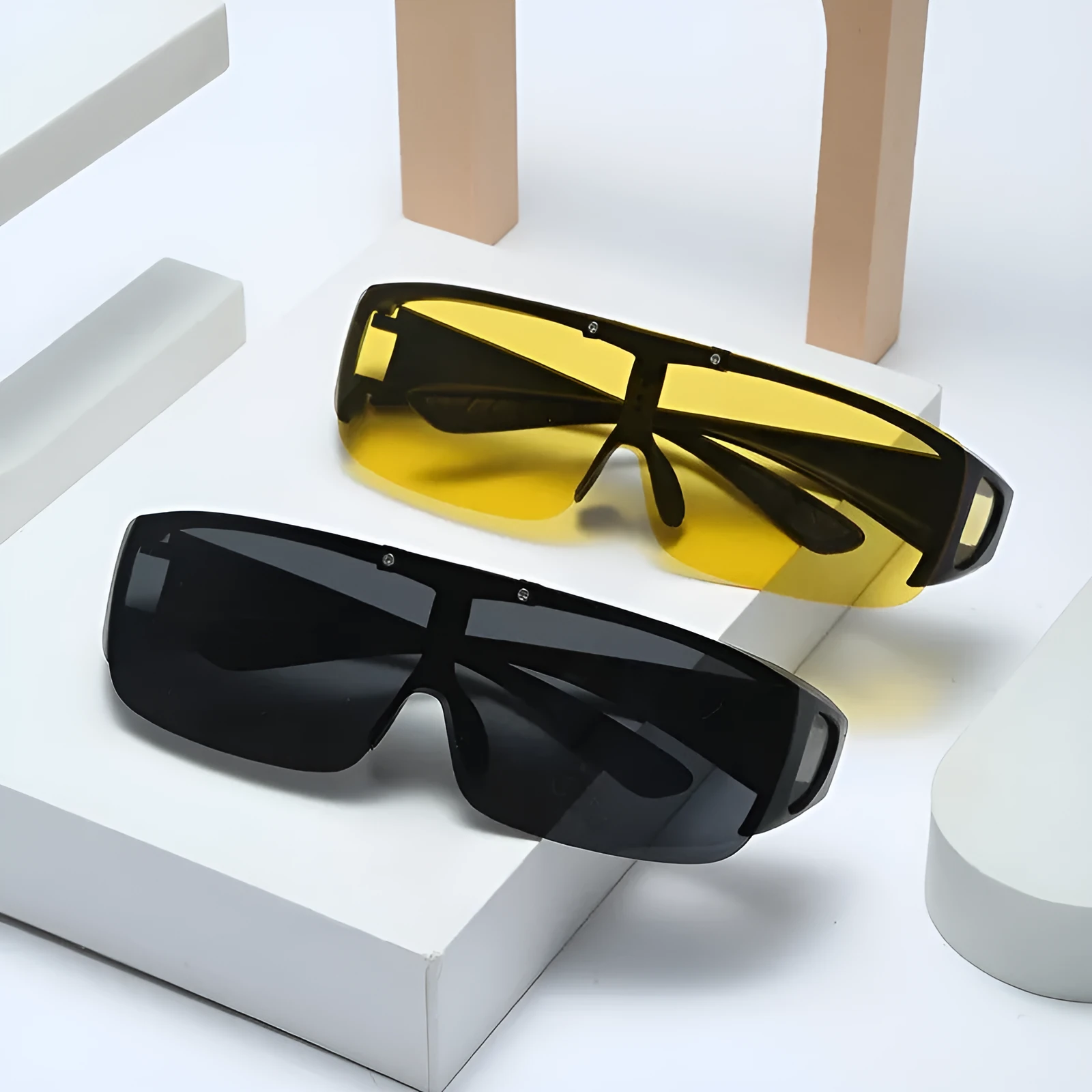 One-piece polarised sunglasses with myopia correction and multiple interchangeable coloured lens sheets laid out.