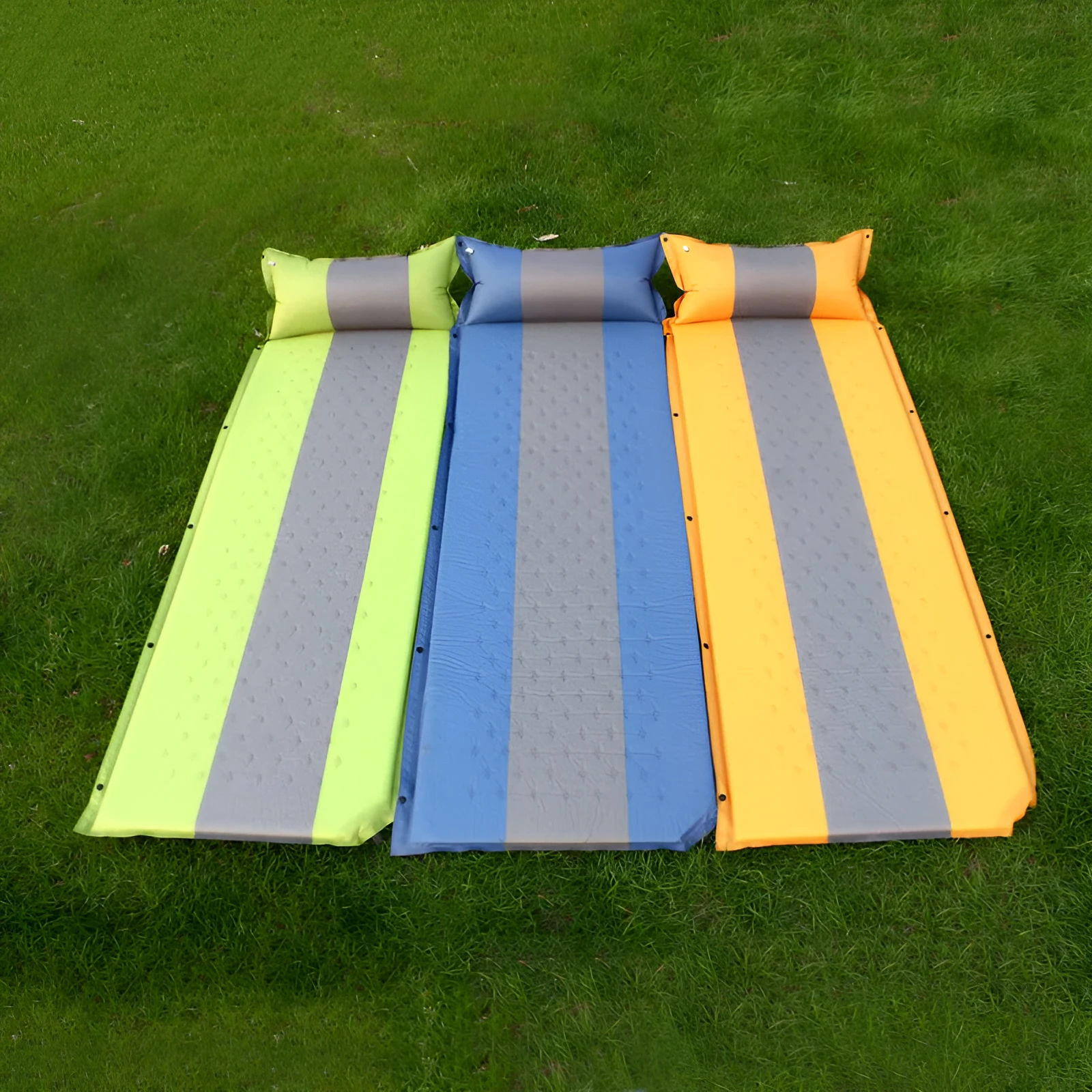 Outdoor automatic inflatable camping mat for one person with memory foam filling, blue and grey colour, shown on grass