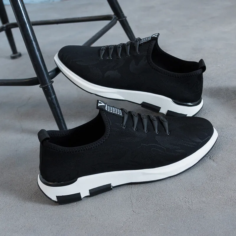 Men's black cloth upper sports casual shoes with rubber sole, low heel, and lace-up closure on a neutral background