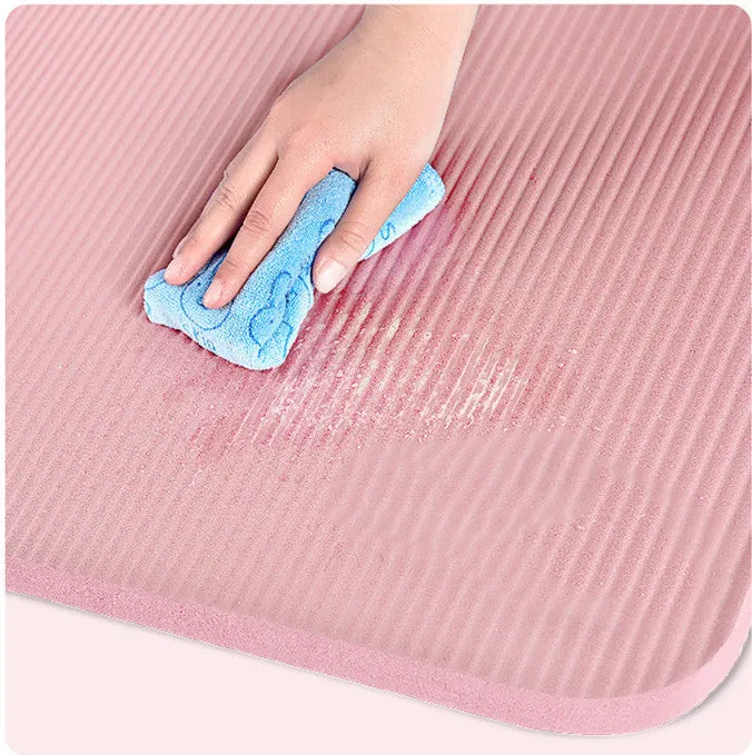 Widened blue TPE yoga mat 183x61cm on floor for home fitness stretching