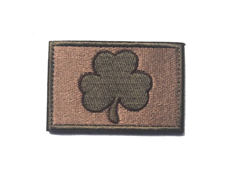 Embroidered fabric badge with Velcro strip showing clover design in green colour