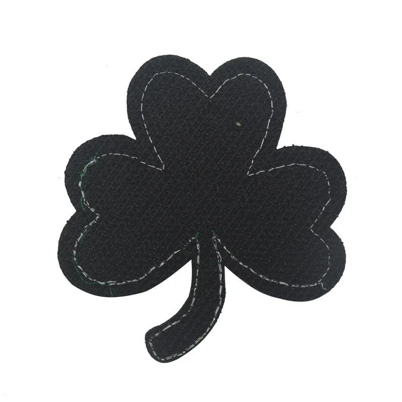 Embroidered fabric badge with Velcro strip showing clover design in green colour