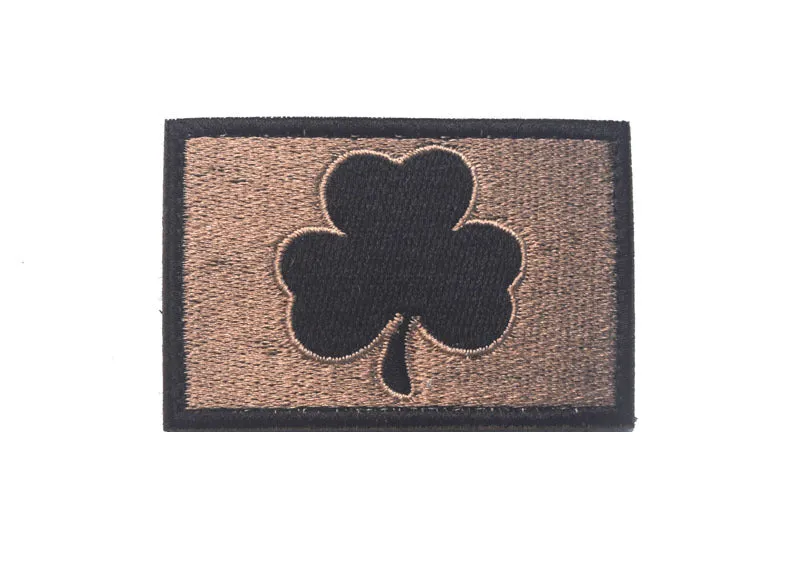 Embroidered fabric badge with Velcro strip showing clover design in green colour