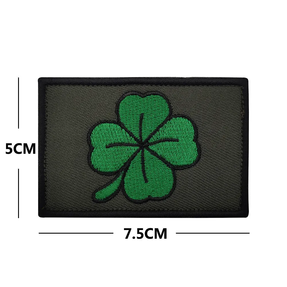 Embroidered fabric badge with Velcro strip showing clover design in green colour
