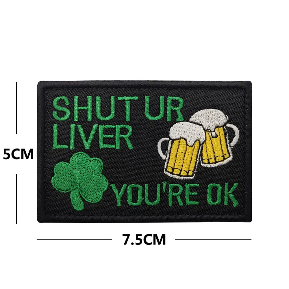 Embroidered fabric badge with Velcro strip showing clover design in green colour