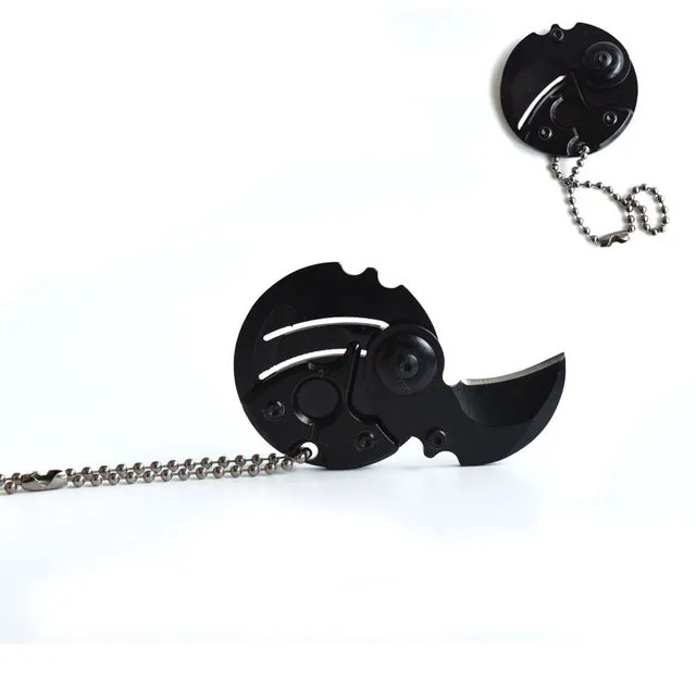 Stainless steel camping survival knife with black aluminium alloy handle on white background