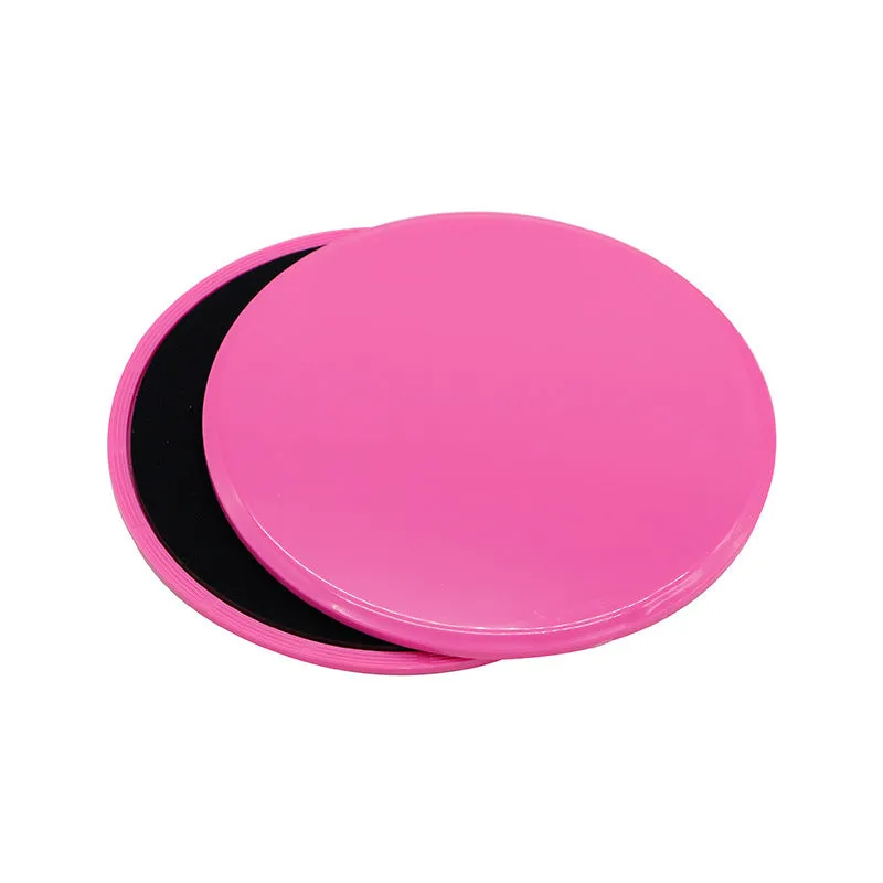 Two pink fitness sliding discs on hard floor showing double-sided texture, 18x18x2cm