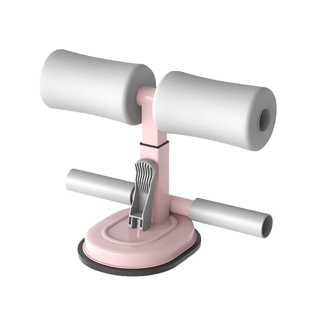 Pink adjustable sit-up bar floor assistant with foam pad and suction base on smooth floor
