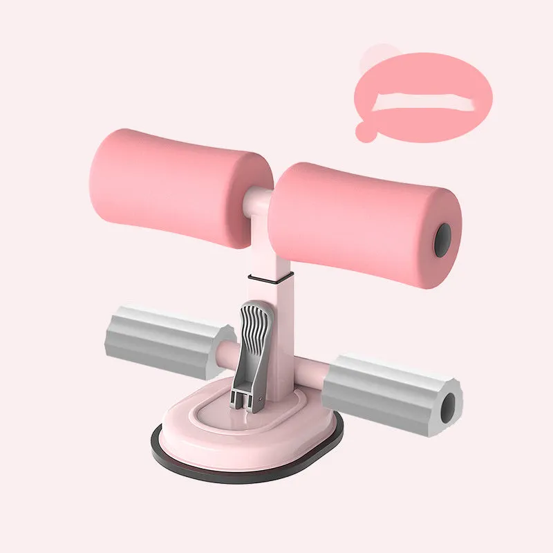 Pink adjustable sit-up bar floor assistant with foam pad and suction base on smooth floor